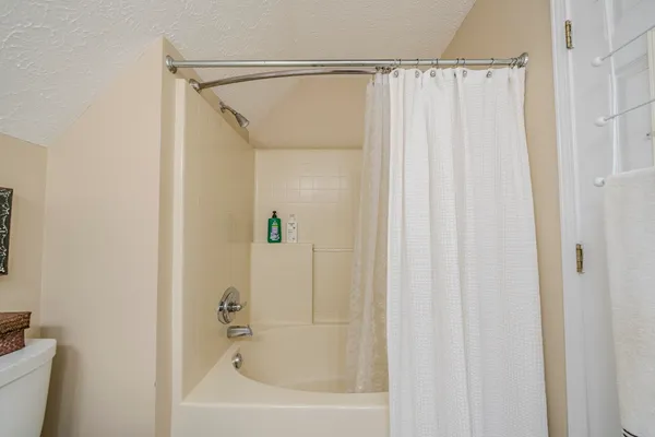 a bathroom with a shower curtain and a sink
