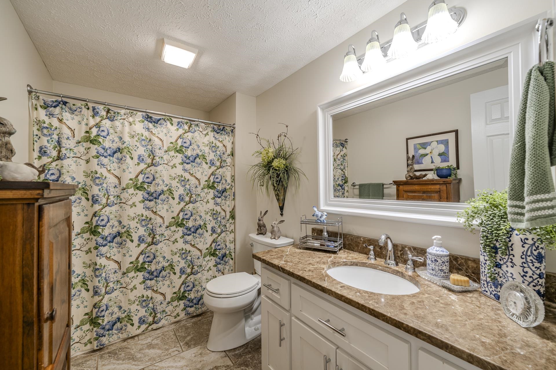 85 Cr 256 Road Iuka, MS 38852 - Photo 24 of 38 Bathroom featuring a single vanity with a white cabinet base, a built-in sink, and a brown patterned countertop