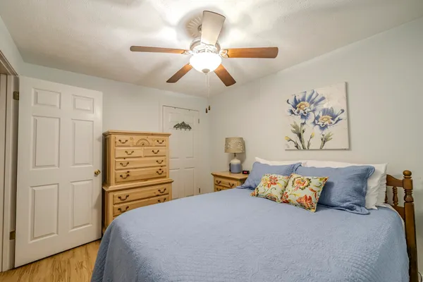 a bedroom with a bed and a chandelier