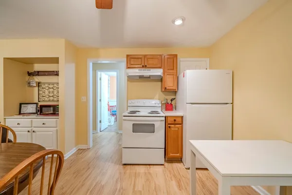 a kitchen with a refrigerator and a stove top oven