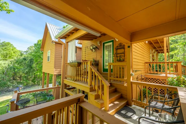 a view of a balcony with wooden floor and fence