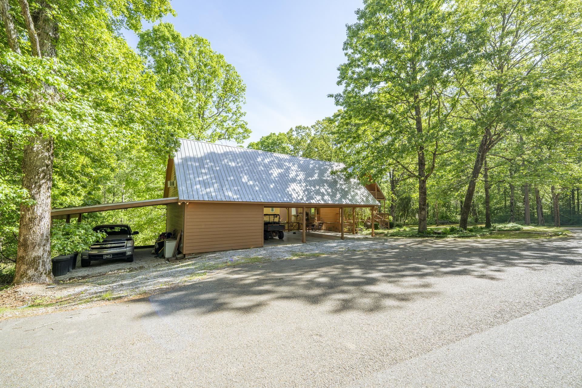 85 Cr 256 Road Iuka, MS 38852 - Photo 38 of 38 Wood-sided structure featuring a metal roof and an attached carport