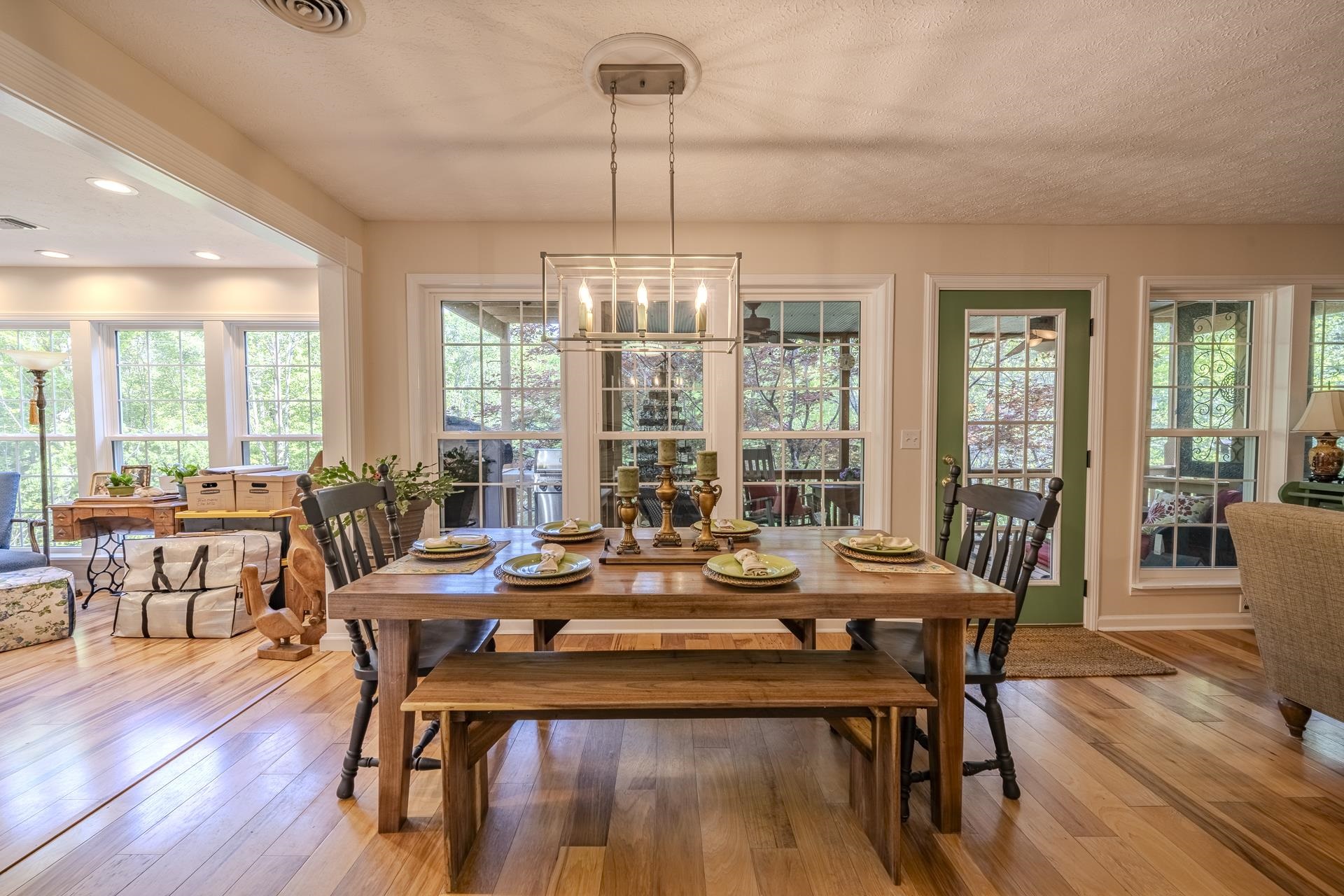85 Cr 256 Road Iuka, MS 38852 - Photo 8 of 38 Dining area featuring wood-finish flooring, a rectangular wood dining table, and a linear chandelier