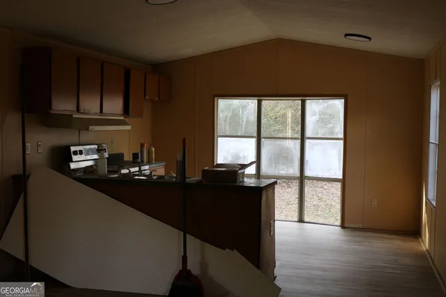 a dining room with furniture window and wooden floor