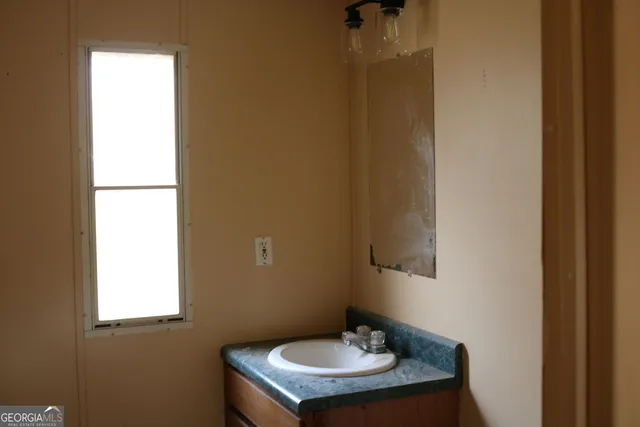 a bathroom with a sink and a mirror