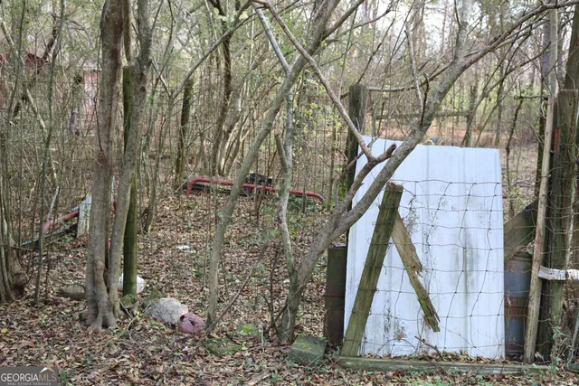 a backyard of a house with lots of trees