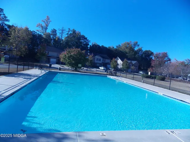 a view of a swimming pool with an outdoor space and seating area