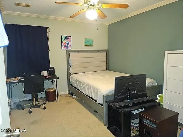 a bedroom with a bed and a desk