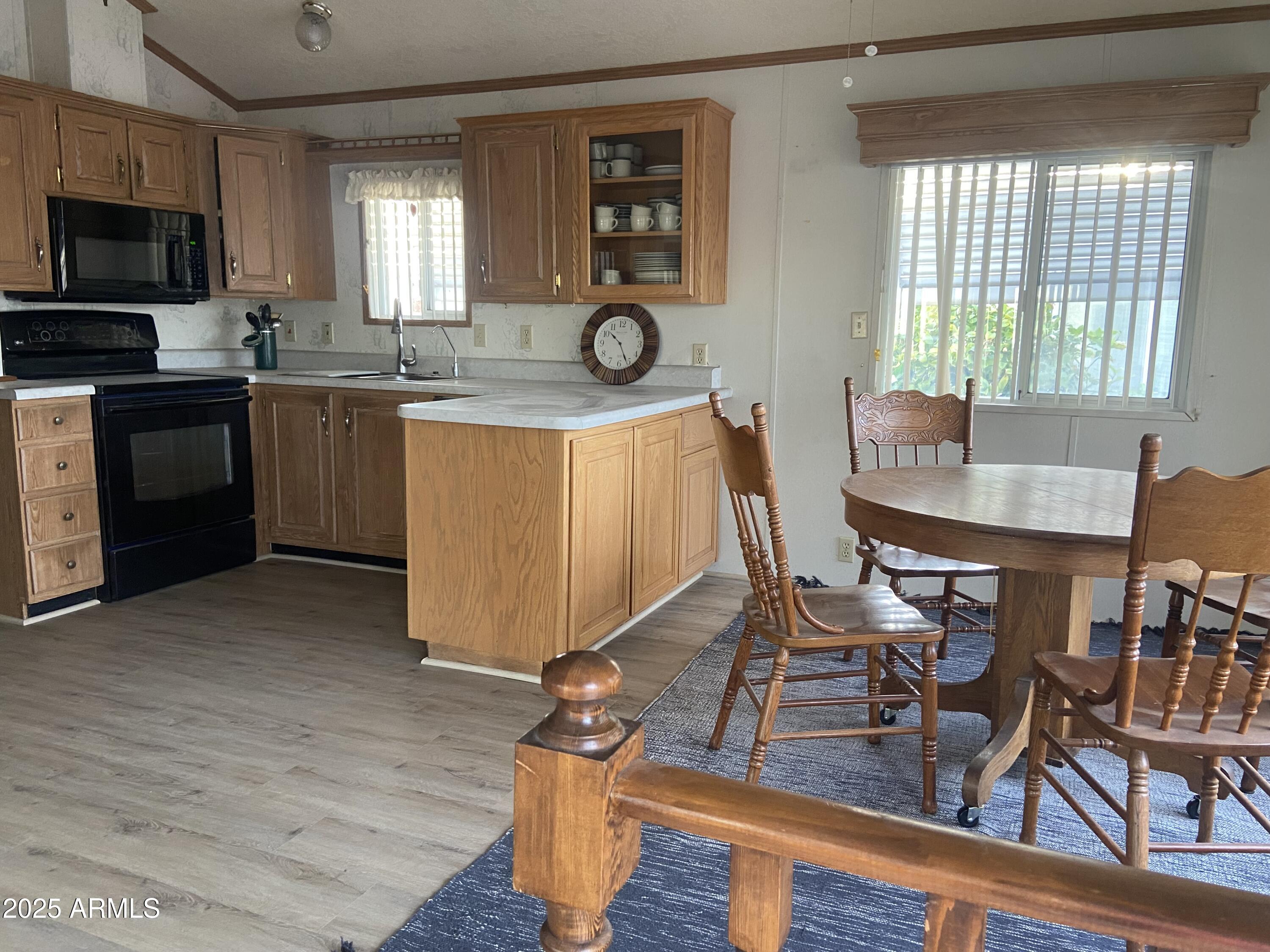 2137 West Erie Avenue, Unit 137 Apache Junction, AZ 85119 - Photo 12 of 36 a view of a kitchen with workspace and wooden floor