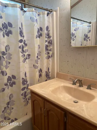 a bathroom with a sink and a shower curtain