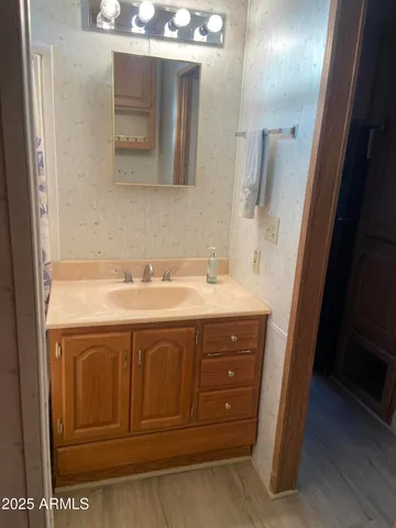 a bathroom with a sink vanity and mirror
