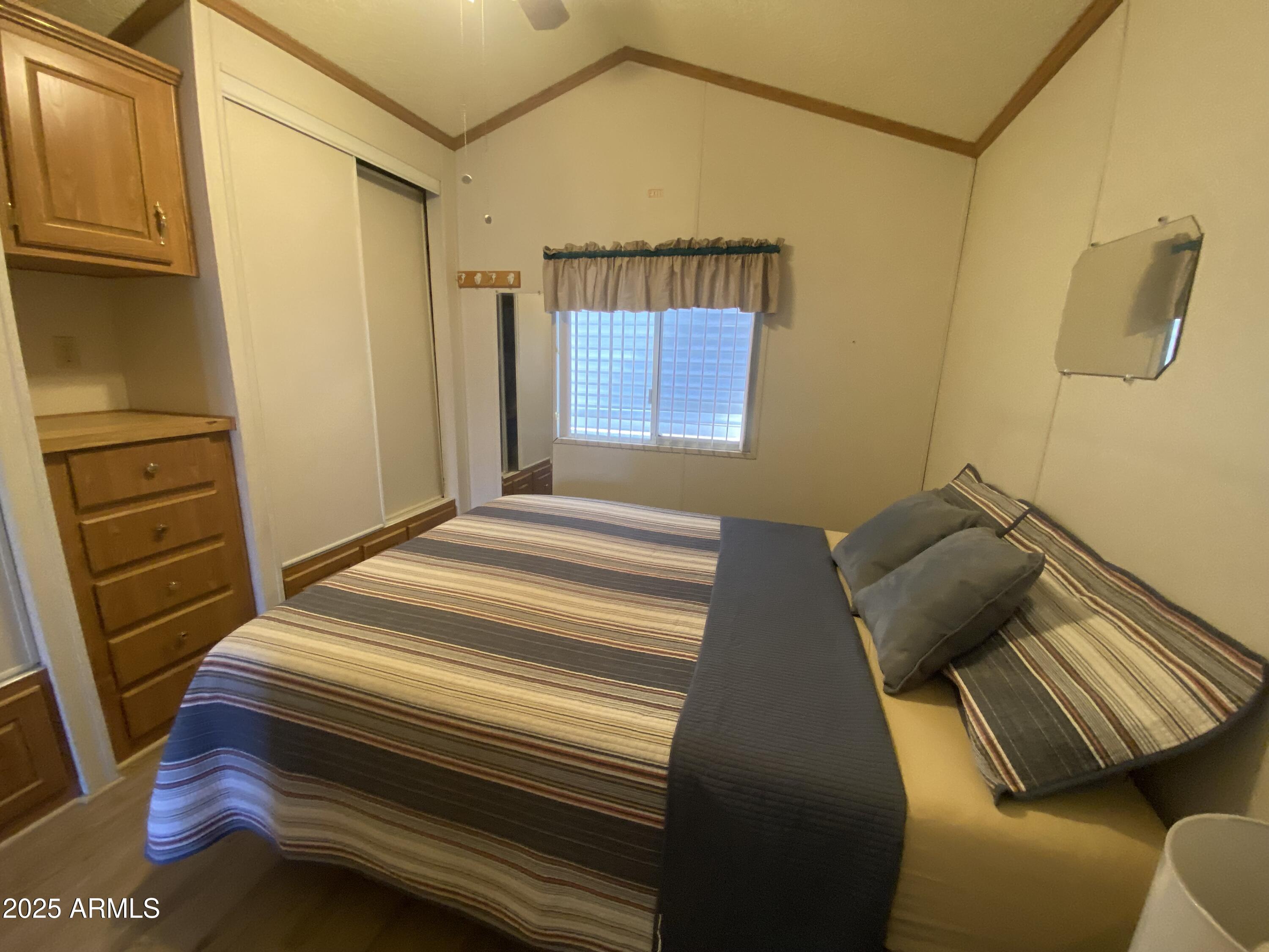 2137 West Erie Avenue, Unit 137 Apache Junction, AZ 85119 - Photo 17 of 36 a bedroom with a bed and furniture