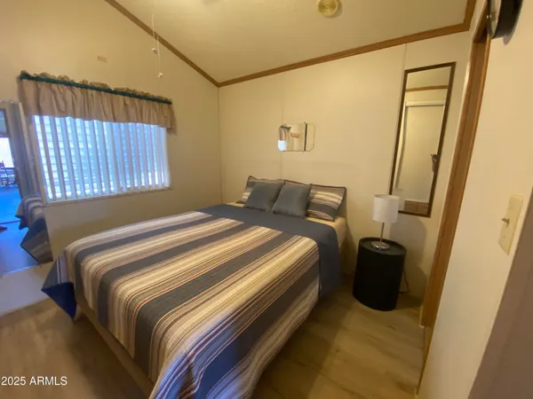 a bedroom with a bed and a window