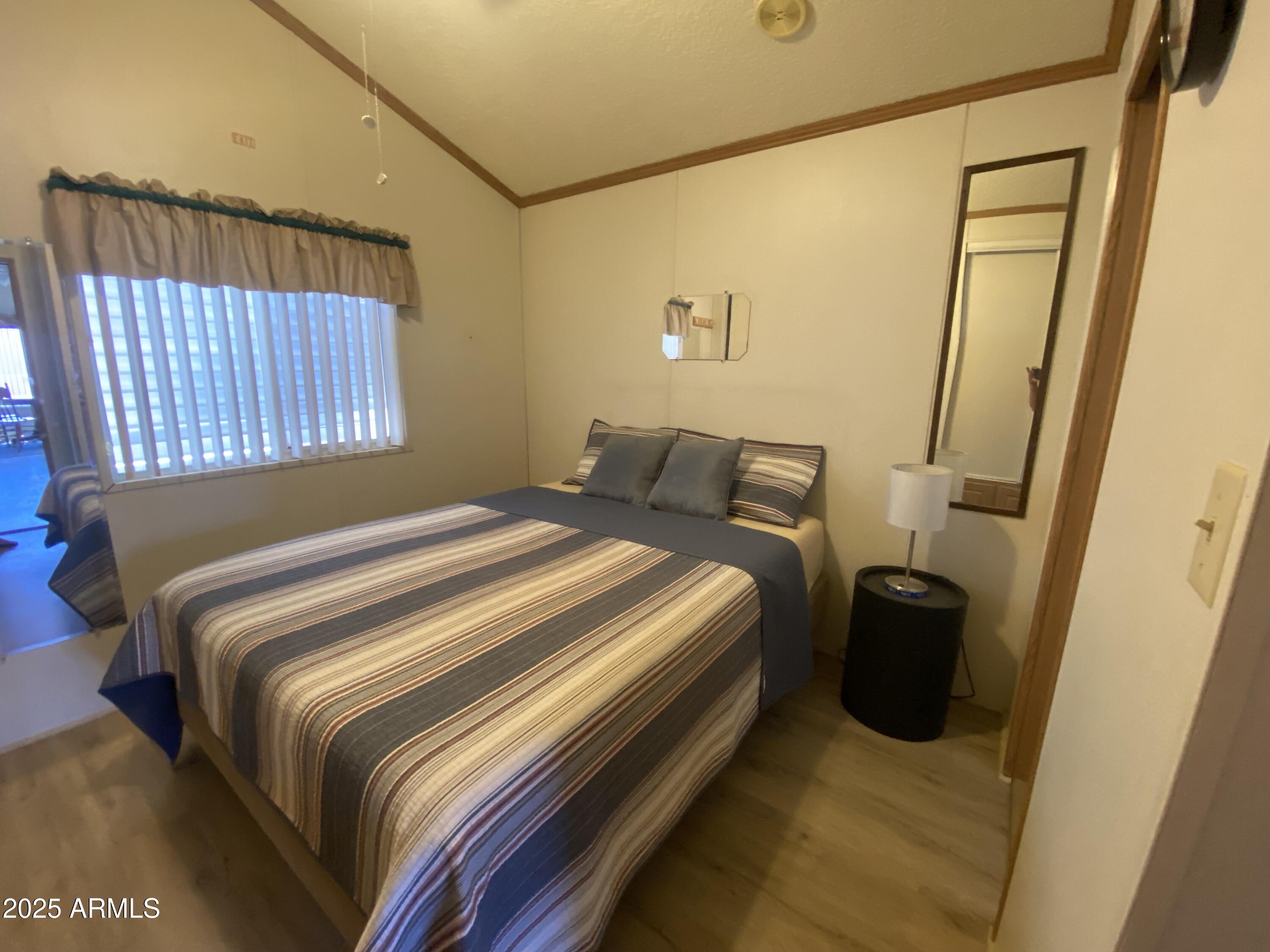 2137 West Erie Avenue, Unit 137 Apache Junction, AZ 85119 - Photo 18 of 36 a bedroom with a bed and a window