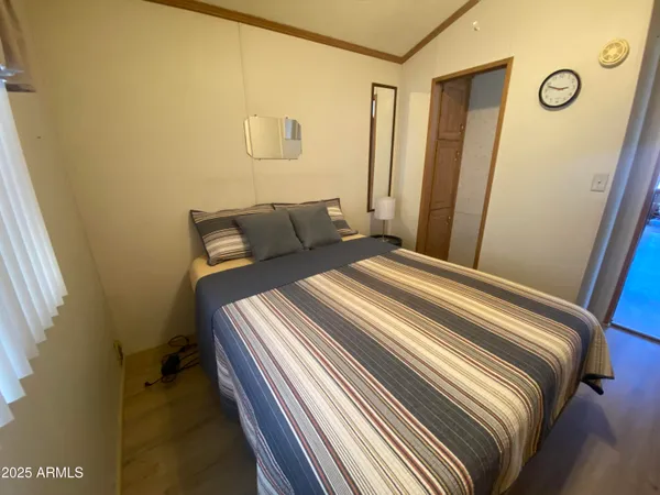 a bedroom with a bed and a mirror