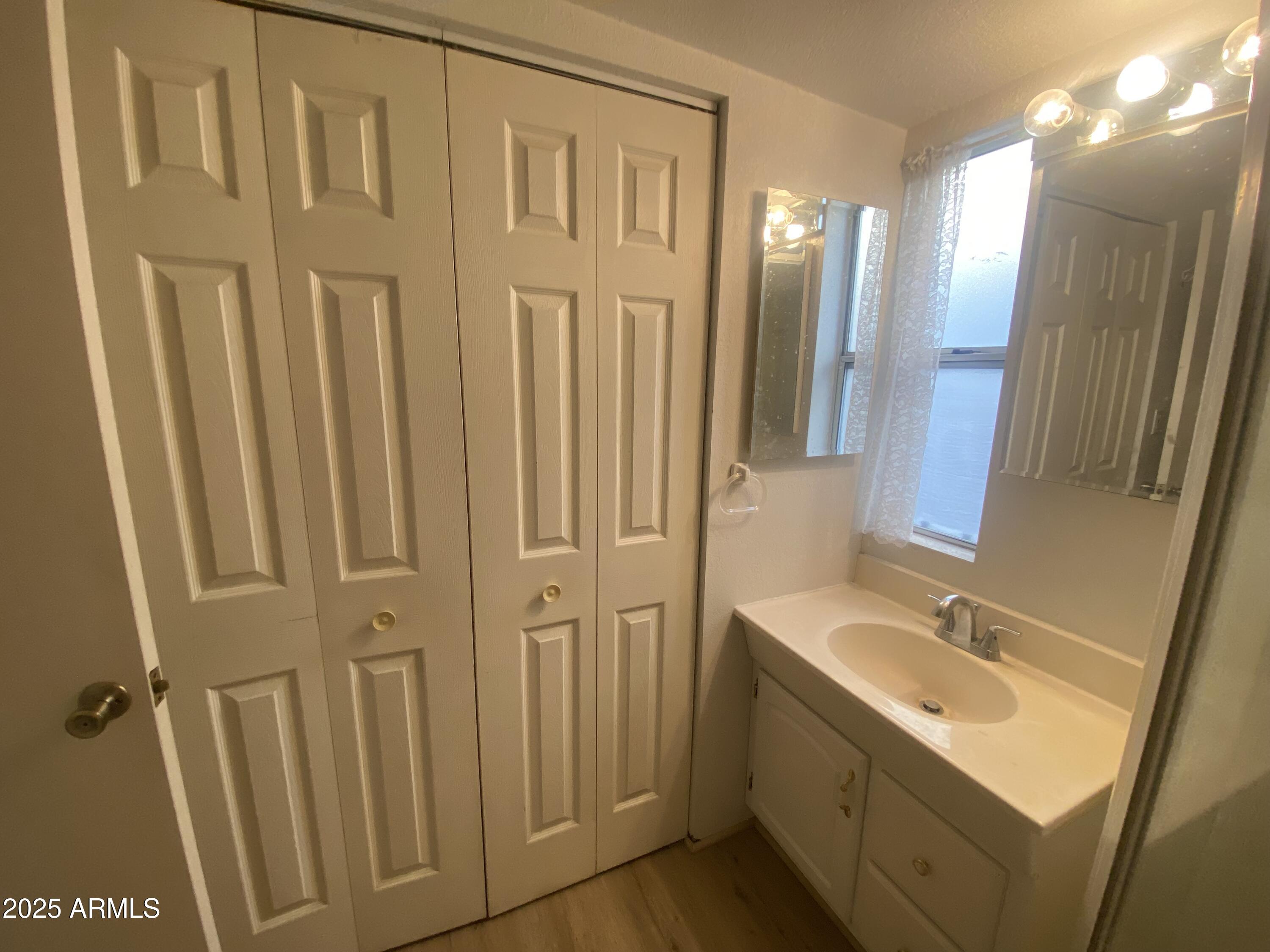 2137 West Erie Avenue, Unit 137 Apache Junction, AZ 85119 - Photo 21 of 36 a bathroom with a sink a mirror and a shower