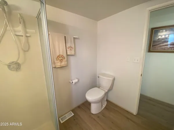 a white toilet sitting next to a bathroom sink
