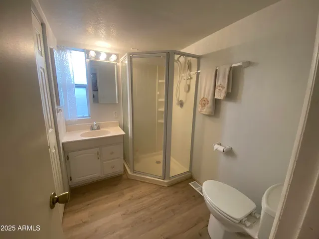 a bathroom with a sink mirror toilet and shower