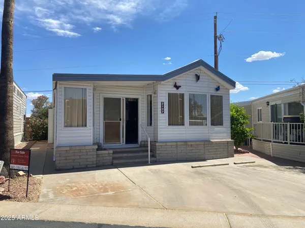 a view of a house with wooden deck