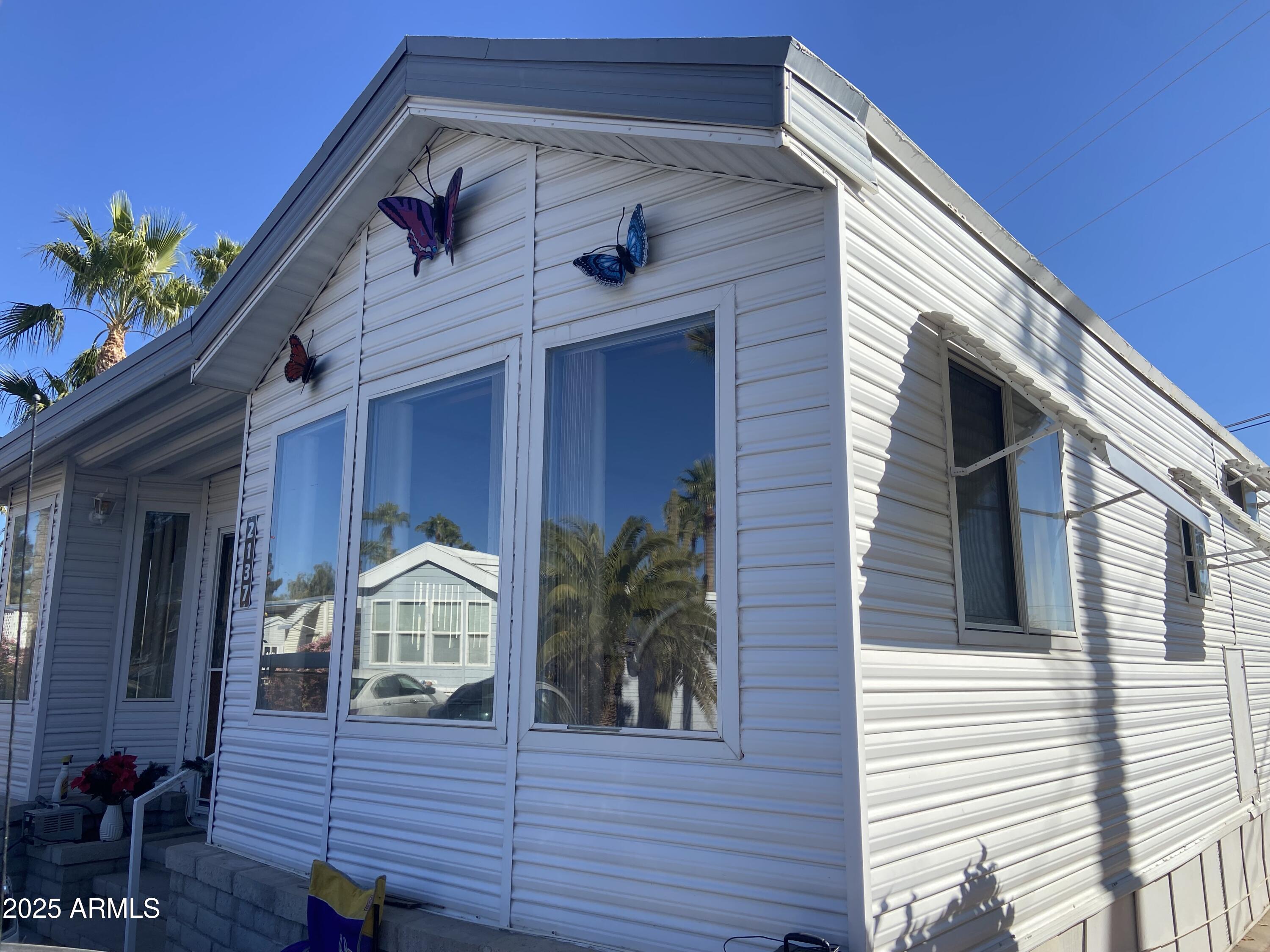 2137 West Erie Avenue, Unit 137 Apache Junction, AZ 85119 - Photo 29 of 36 a view of a house with wooden deck