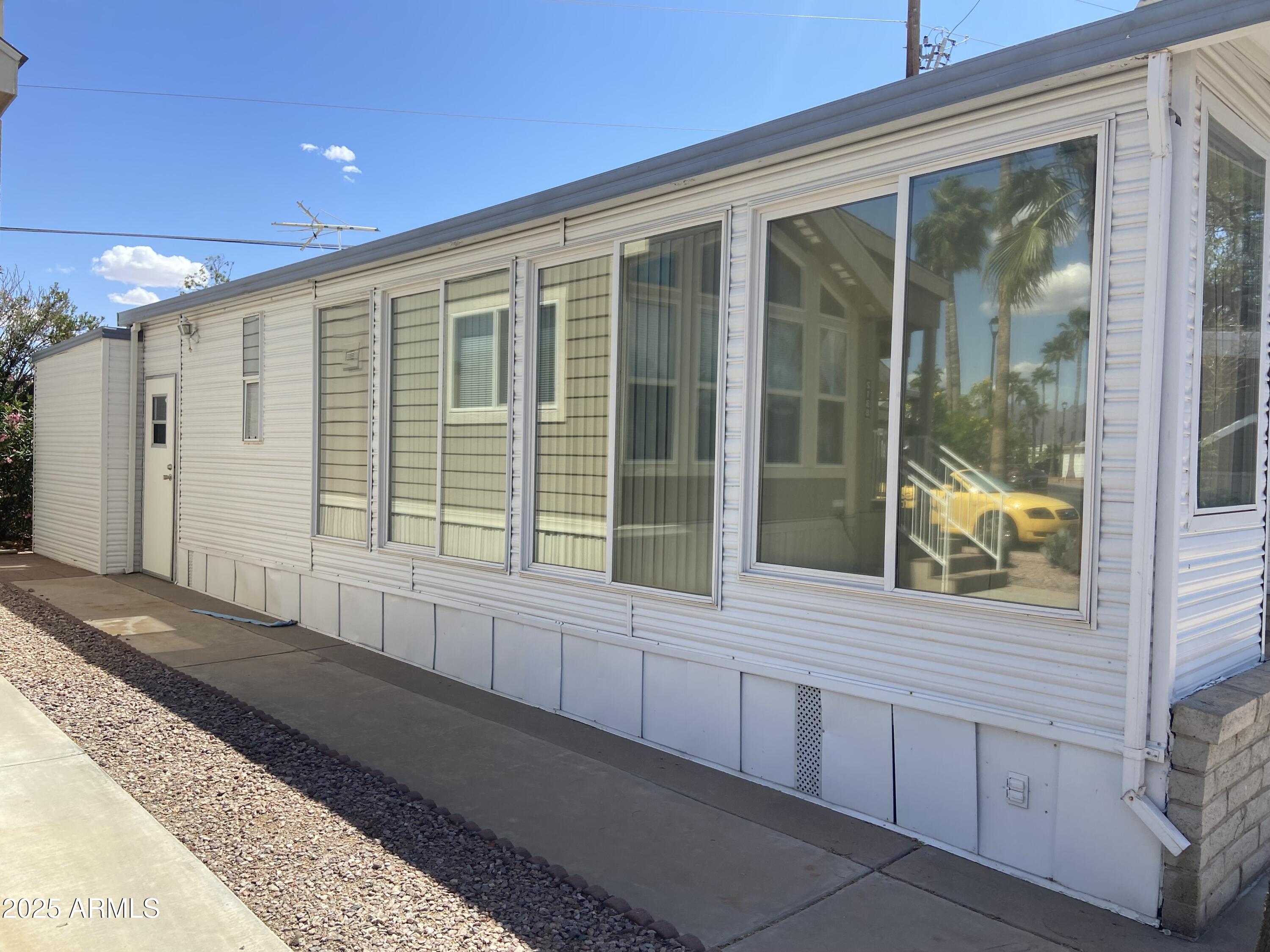 2137 West Erie Avenue, Unit 137 Apache Junction, AZ 85119 - Photo 30 of 36 a view of a house with a large windows