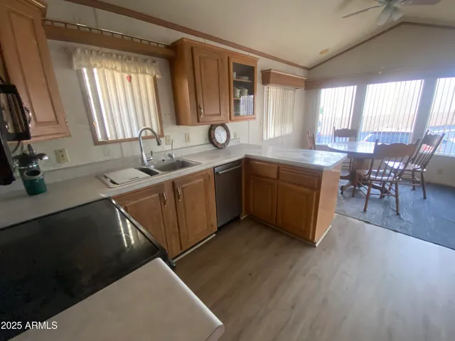 a kitchen with sink cabinets and wooden floor