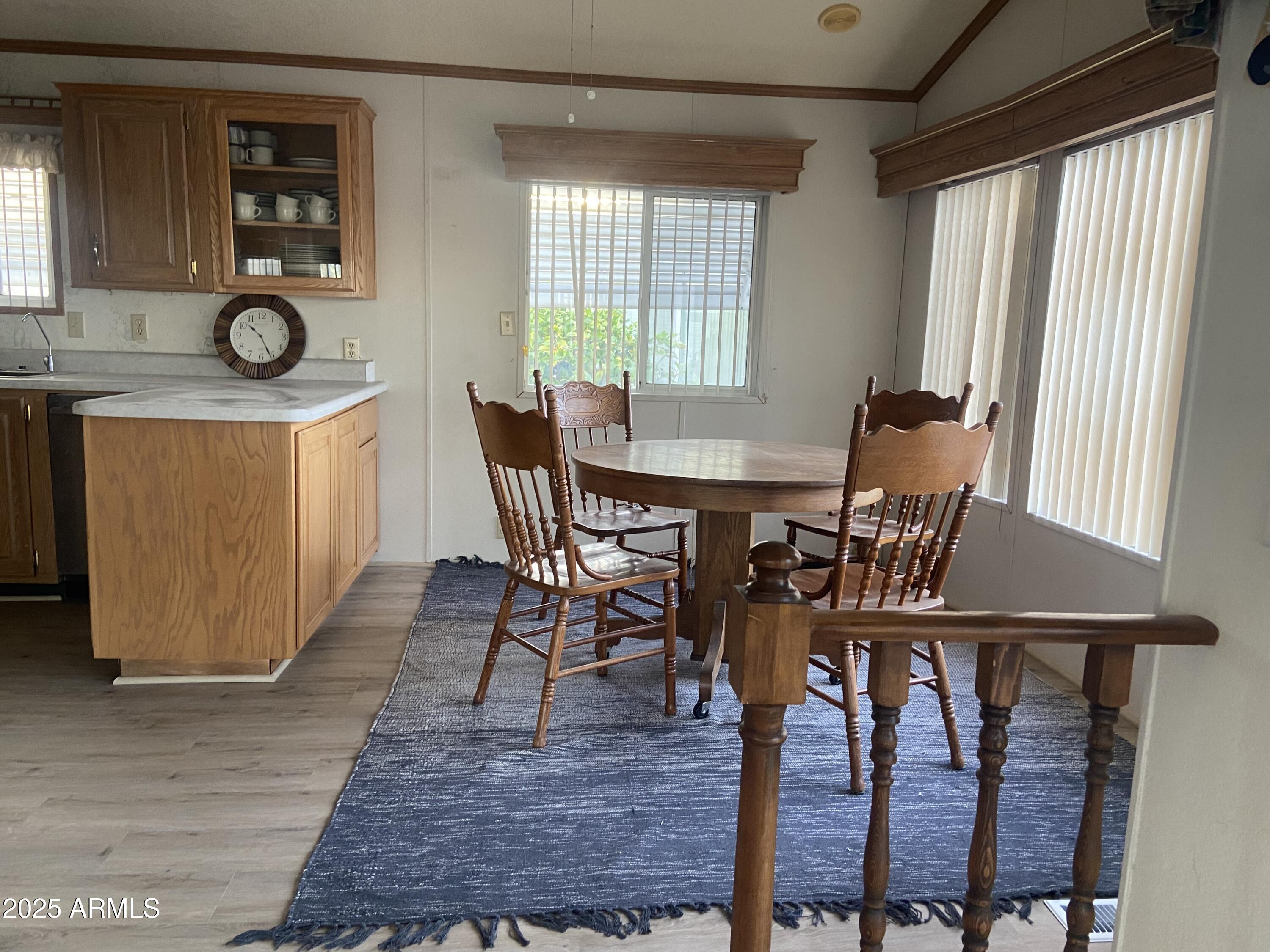 2137 West Erie Avenue, Unit 137 Apache Junction, AZ 85119 - Photo 8 of 36 a view of a dining room with furniture and window