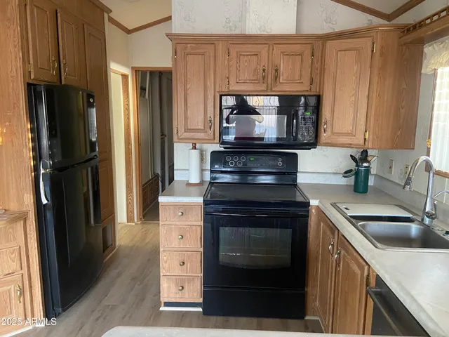 a kitchen with a refrigerator stove and sink