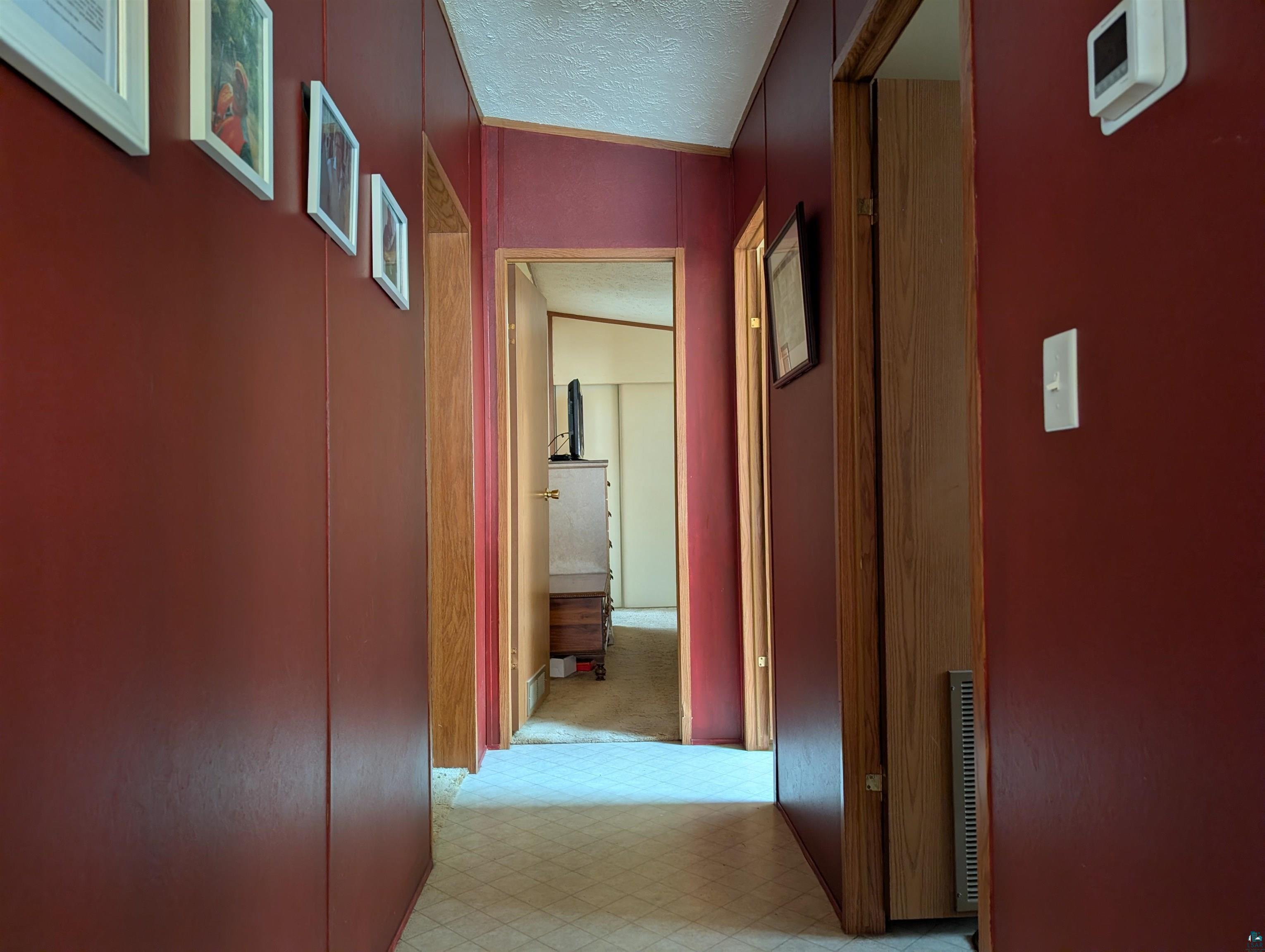 54700 Cudworth Avenue Grand View, WI 54839 - Photo 14 of 21 Corridor featuring a textured ceiling and light flooring