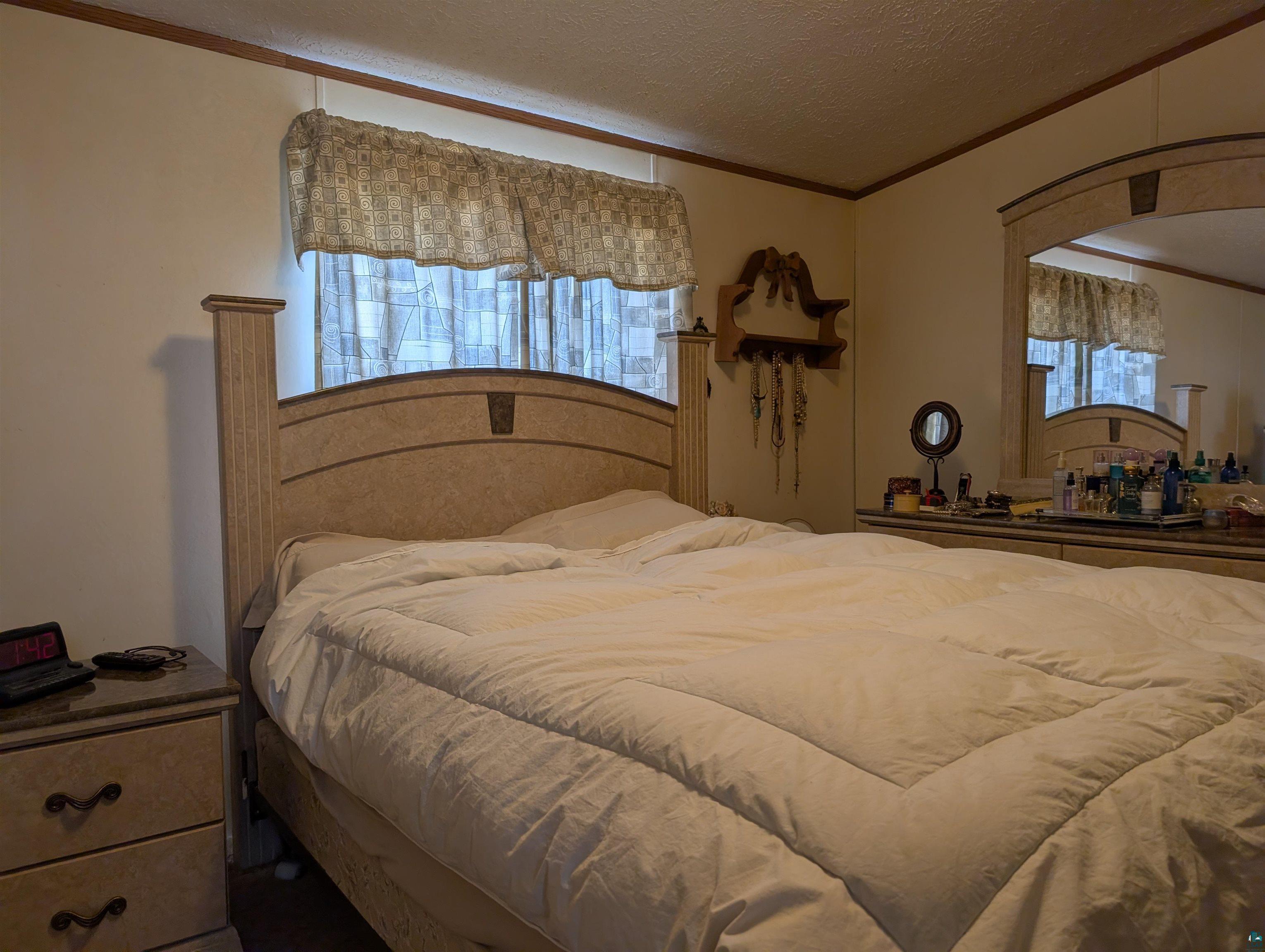 54700 Cudworth Avenue Grand View, WI 54839 - Photo 15 of 21 Bedroom with ornamental molding, a textured ceiling, and arched walkways