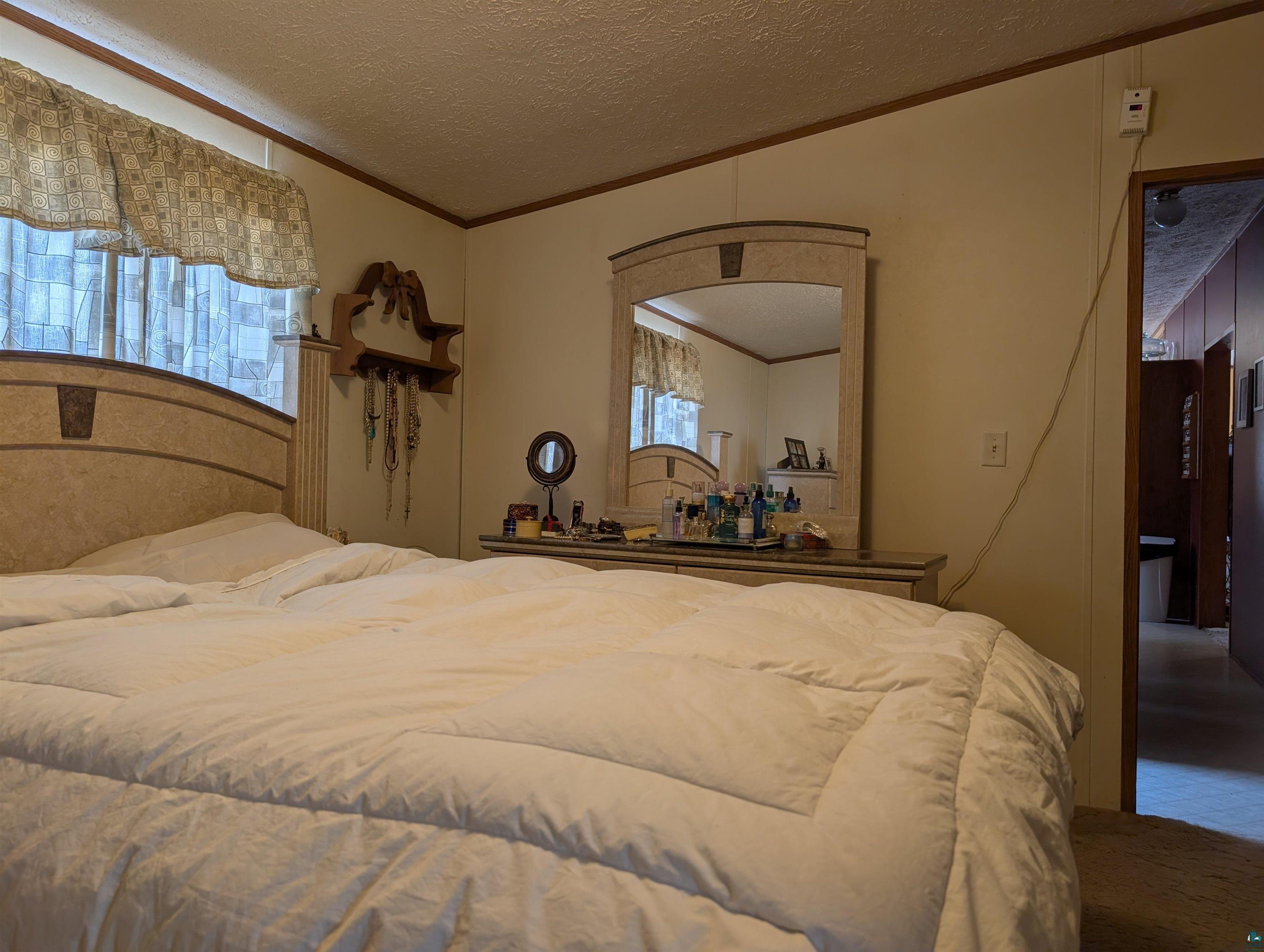 54700 Cudworth Avenue Grand View, WI 54839 - Photo 16 of 21 Bedroom with ornamental molding and a textured ceiling