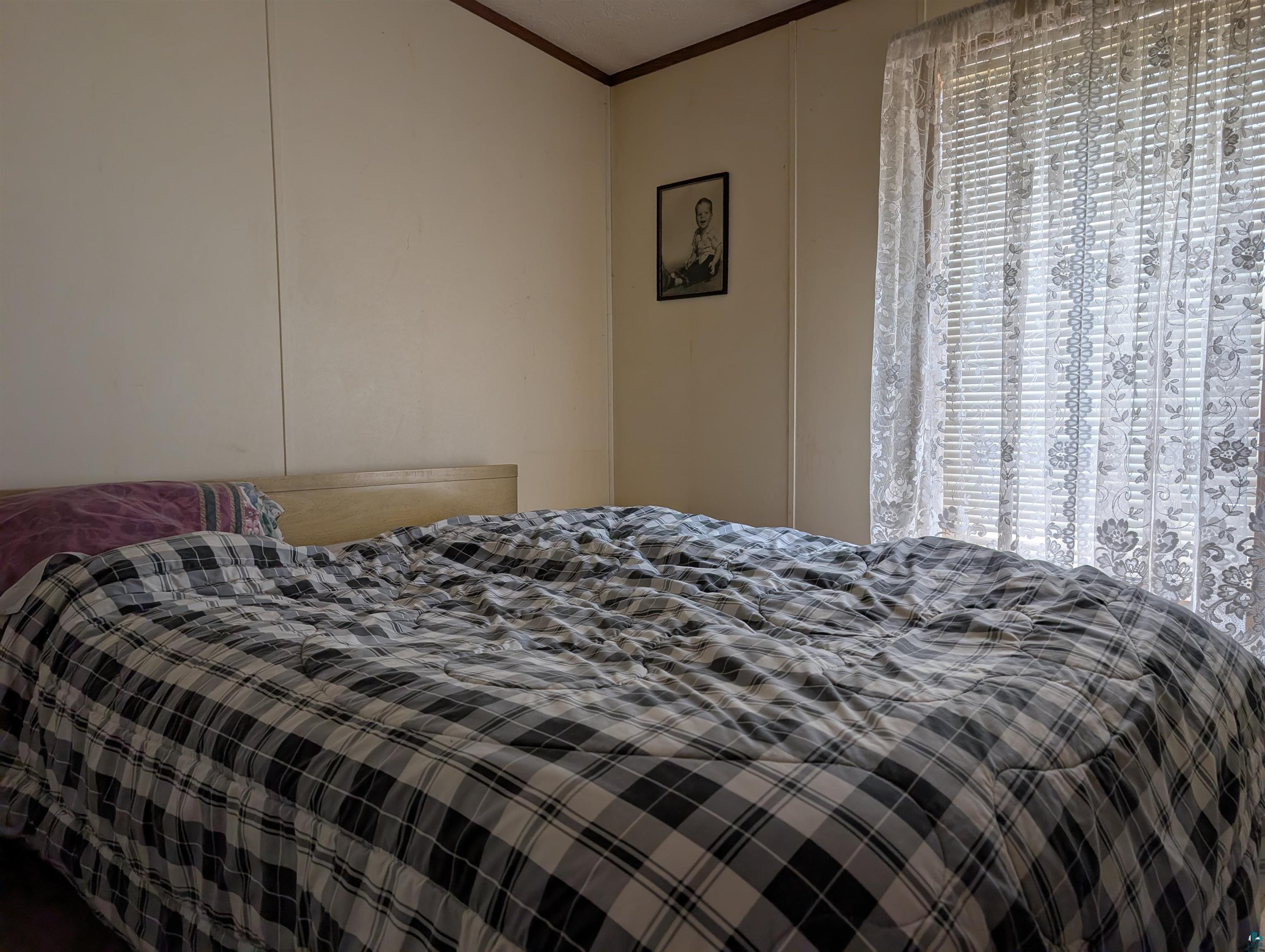 54700 Cudworth Avenue Grand View, WI 54839 - Photo 19 of 21 Bedroom featuring ornamental molding and multiple windows