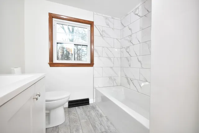 a white bath tub sitting next to a white toilet