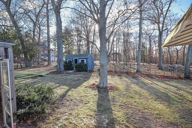 a front view of a house with a yard and fountain