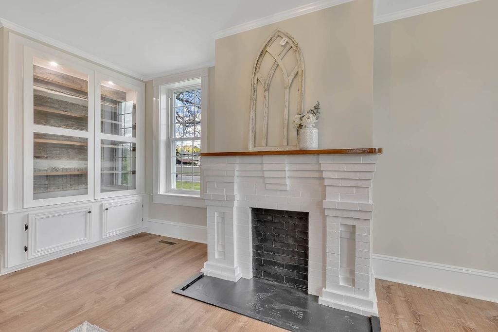 800 River Road Beaver, PA 15009 - Photo 11 of 47 a living room with a fireplace and a wooden floor