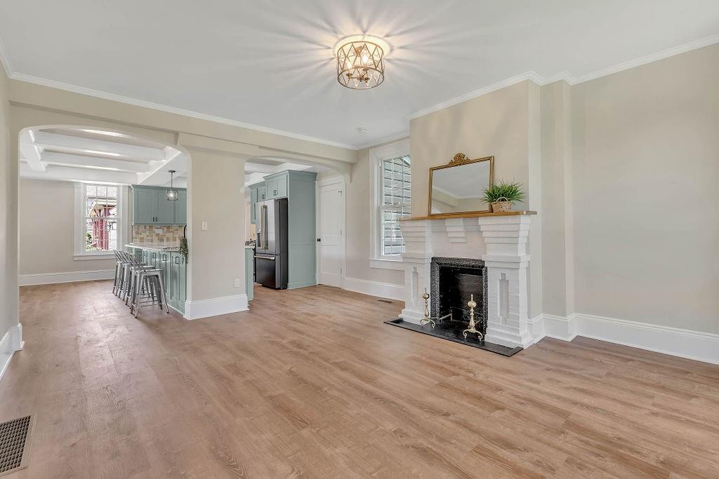 800 River Road Beaver, PA 15009 - Photo 17 of 47 a view of a livingroom with a fireplace a chandelier and wooden floor