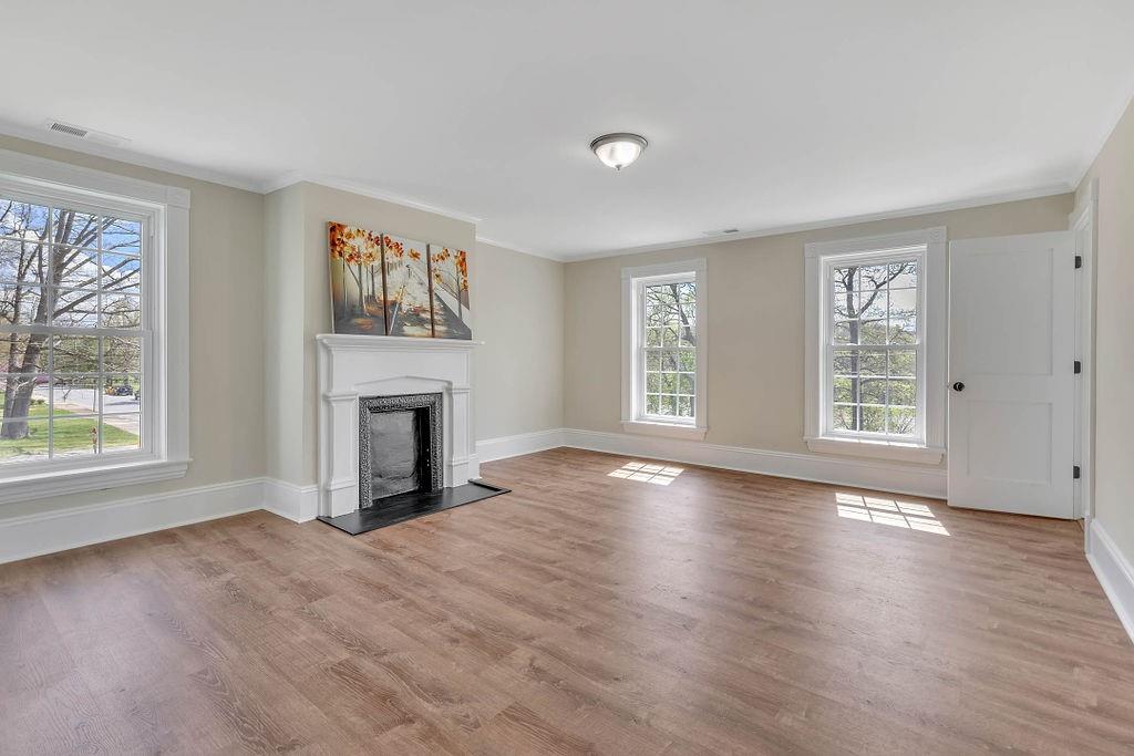 800 River Road Beaver, PA 15009 - Photo 24 of 47 an empty room with windows a fireplace and wooden floor