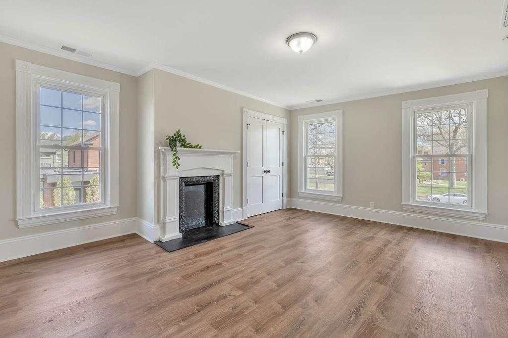 800 River Road Beaver, PA 15009 - Photo 31 of 47 an empty room with windows a fireplace and wooden floor