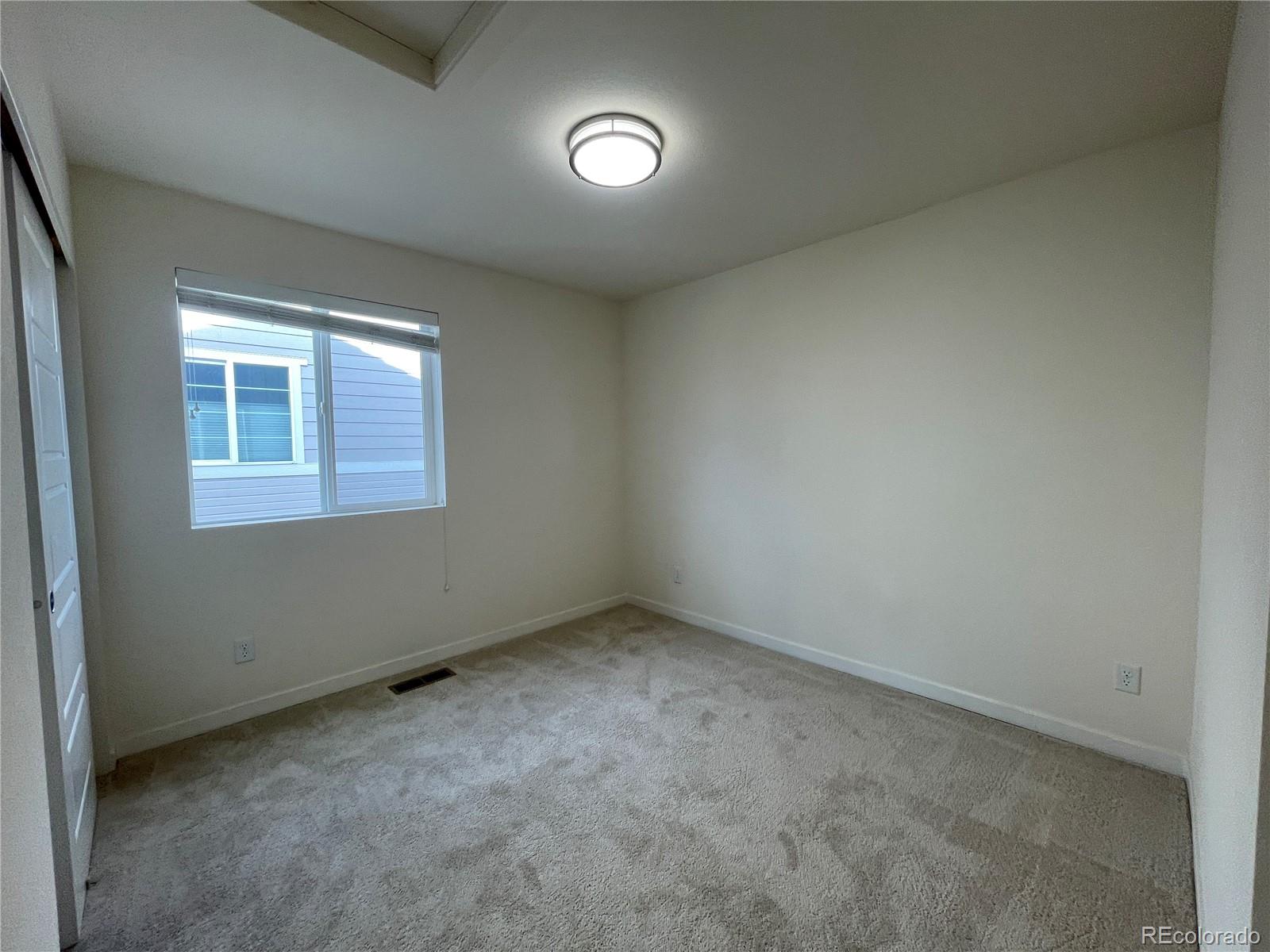 10951 Touchstone Loop Parker, CO 80134 - Photo 14 of 35 an empty room with a window