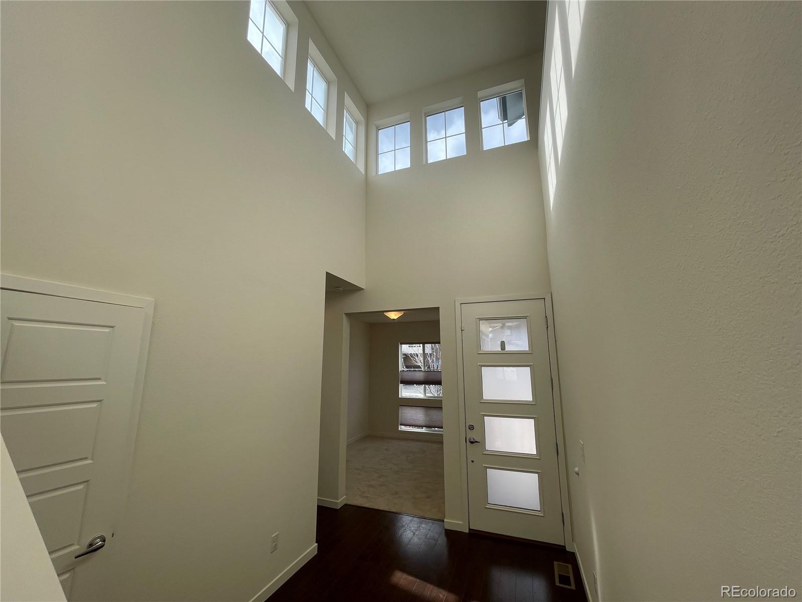 10951 Touchstone Loop Parker, CO 80134 - Photo 18 of 35 a view of a hallway with wooden floor and entryway