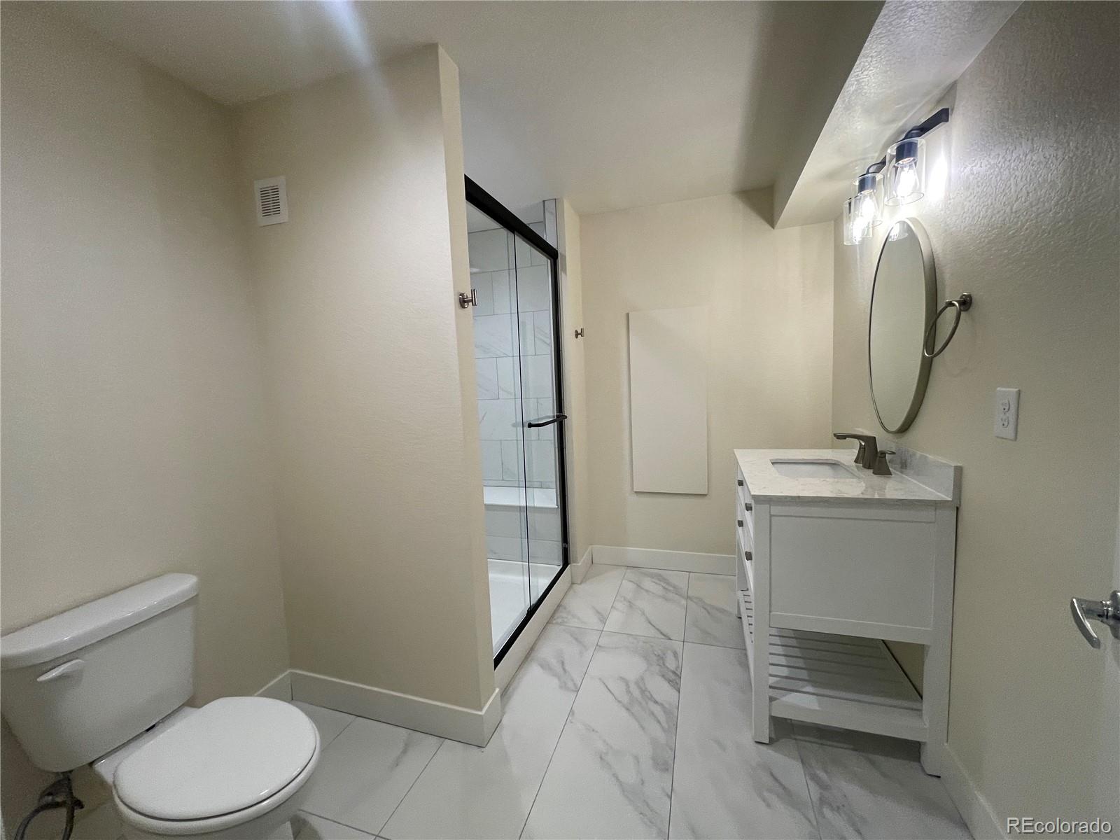 10951 Touchstone Loop Parker, CO 80134 - Photo 20 of 35 a bathroom with a sink a toilet and shower