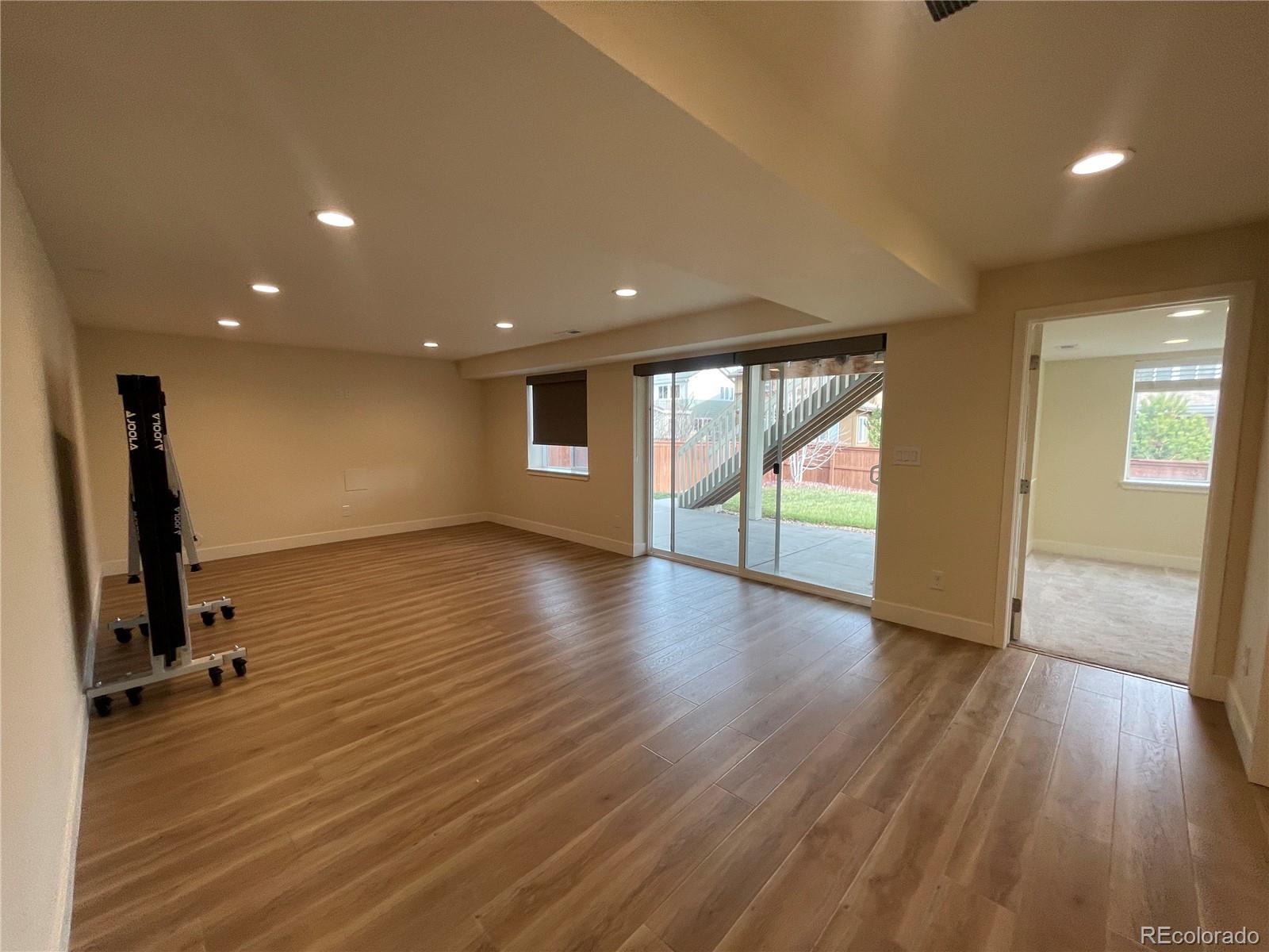 10951 Touchstone Loop Parker, CO 80134 - Photo 23 of 35 an empty room with wooden floor and windows