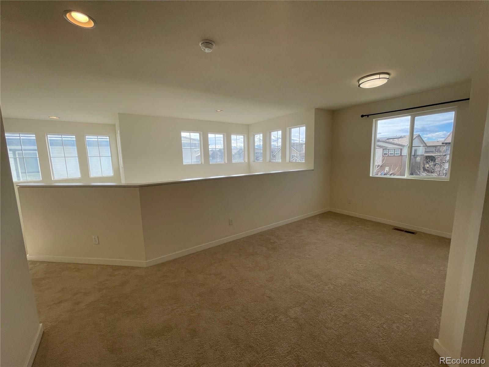 10951 Touchstone Loop Parker, CO 80134 - Photo 6 of 35 an empty room with windows