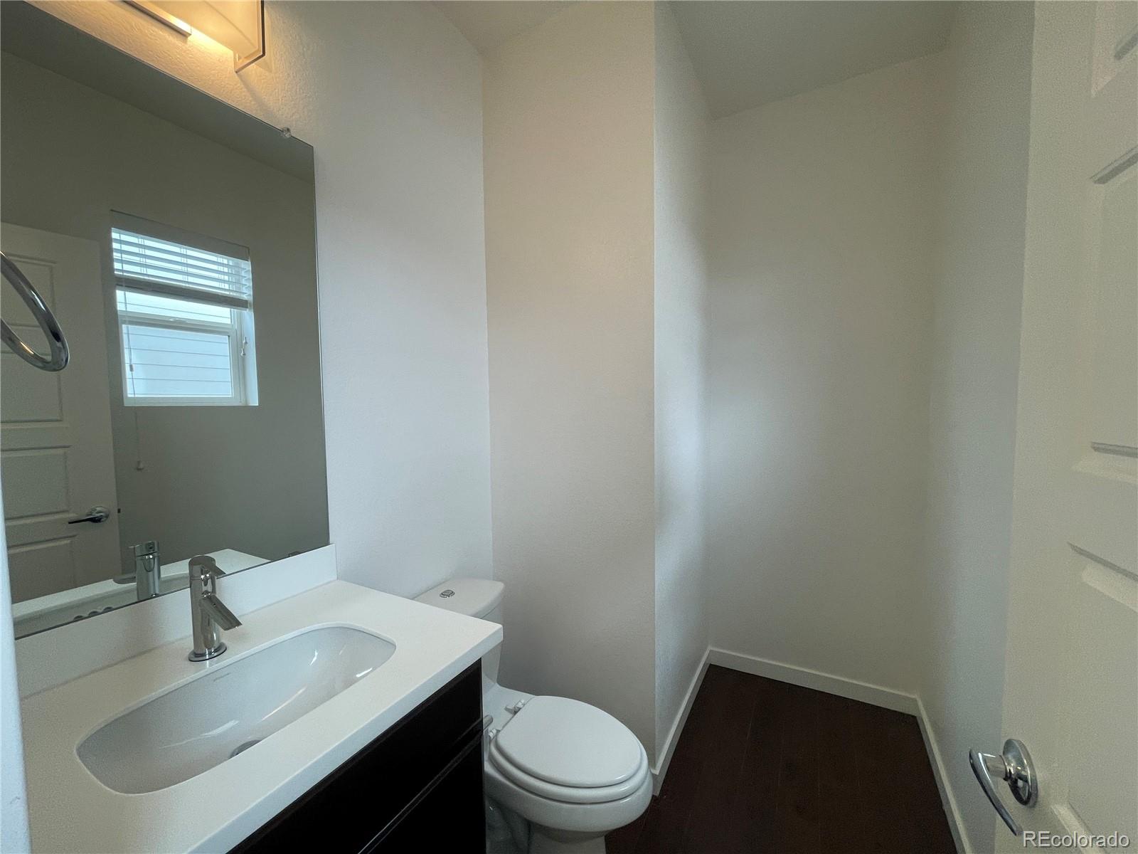 10951 Touchstone Loop Parker, CO 80134 - Photo 8 of 35 a bathroom with a sink toilet and a mirror