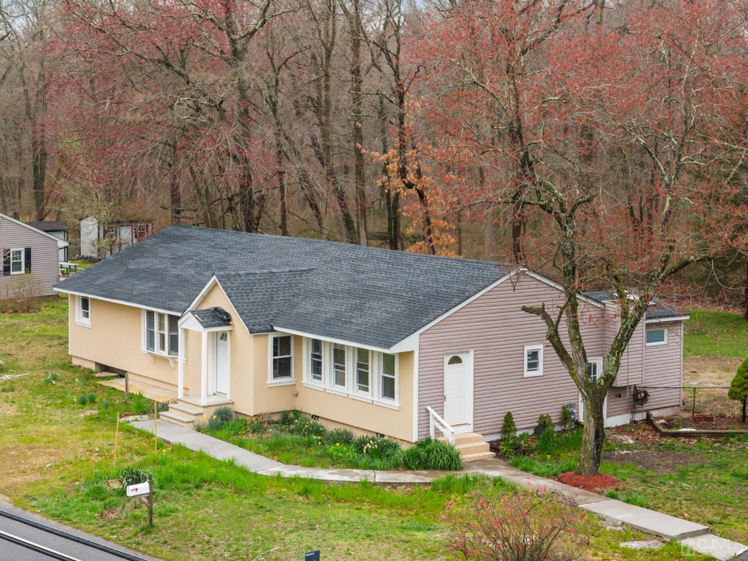 145 Texas Road Old Bridge, NJ 08857 - Photo 1 of 35 a aerial view of a house next to a yard with big trees