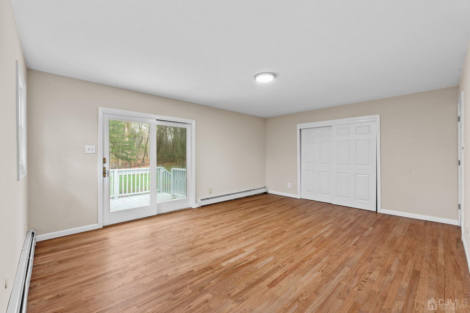 145 Texas Road Old Bridge, NJ 08857 - Photo 11 of 35 a view of an empty room with wooden floor and a window