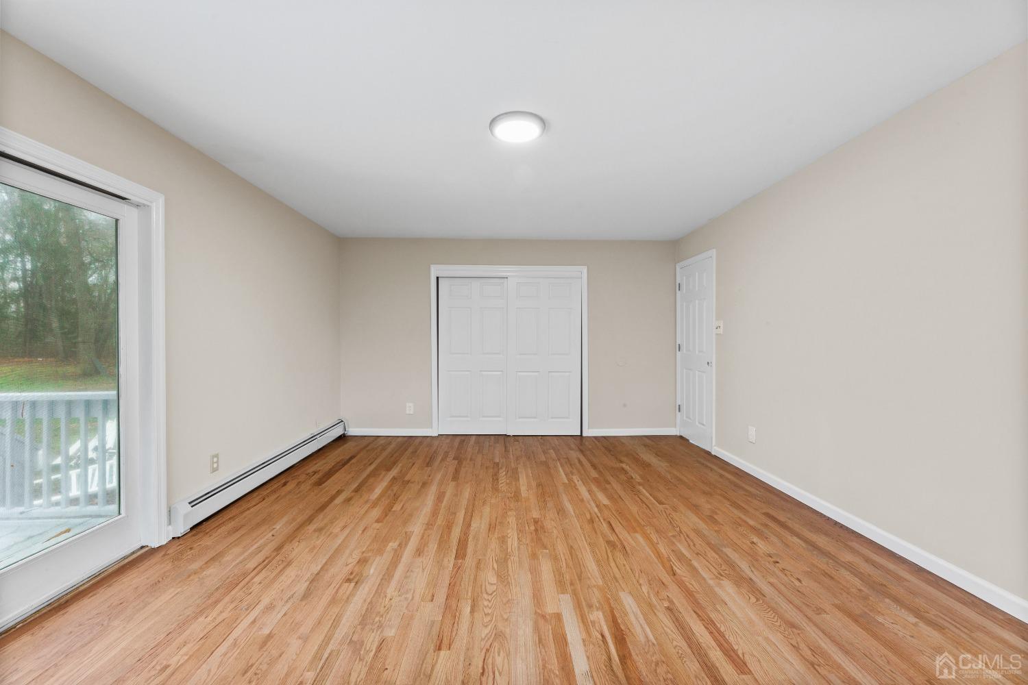145 Texas Road Old Bridge, NJ 08857 - Photo 14 of 35 a view of an empty room with wooden floor and a window