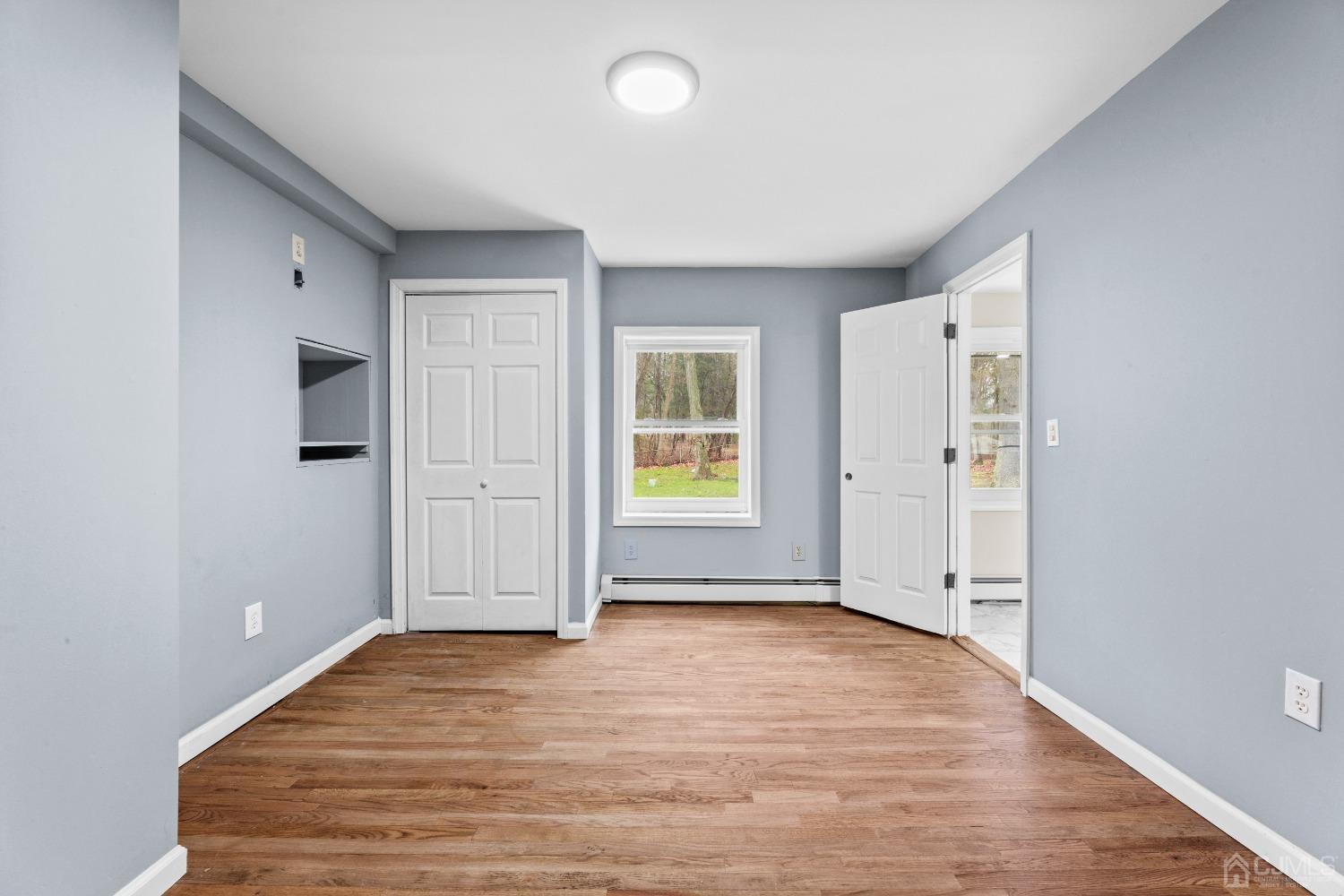 145 Texas Road Old Bridge, NJ 08857 - Photo 23 of 35 an empty room with wooden floor and windows