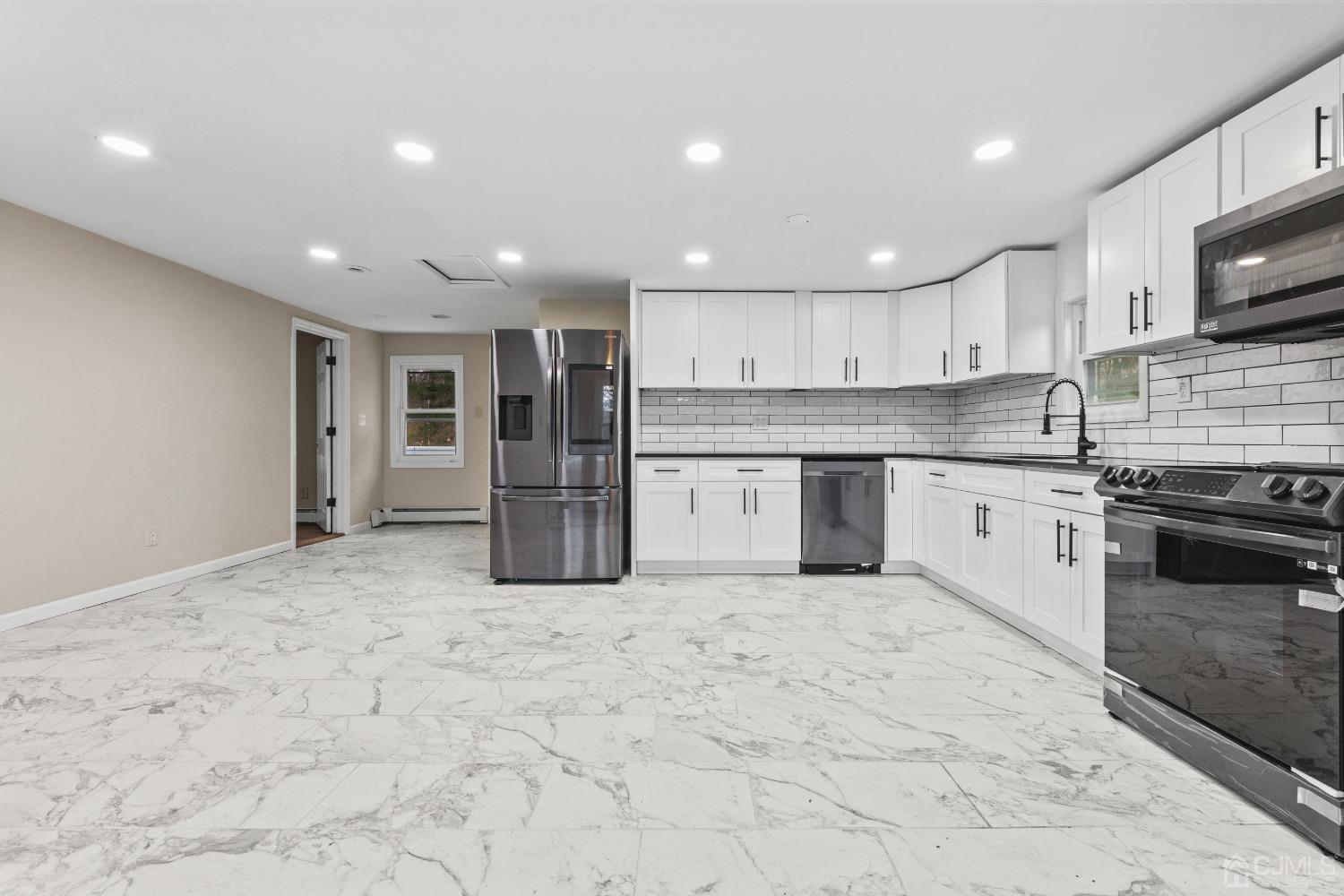145 Texas Road Old Bridge, NJ 08857 - Photo 31 of 35 a kitchen with stainless steel appliances granite countertop a stove top oven a sink and a refrigerator