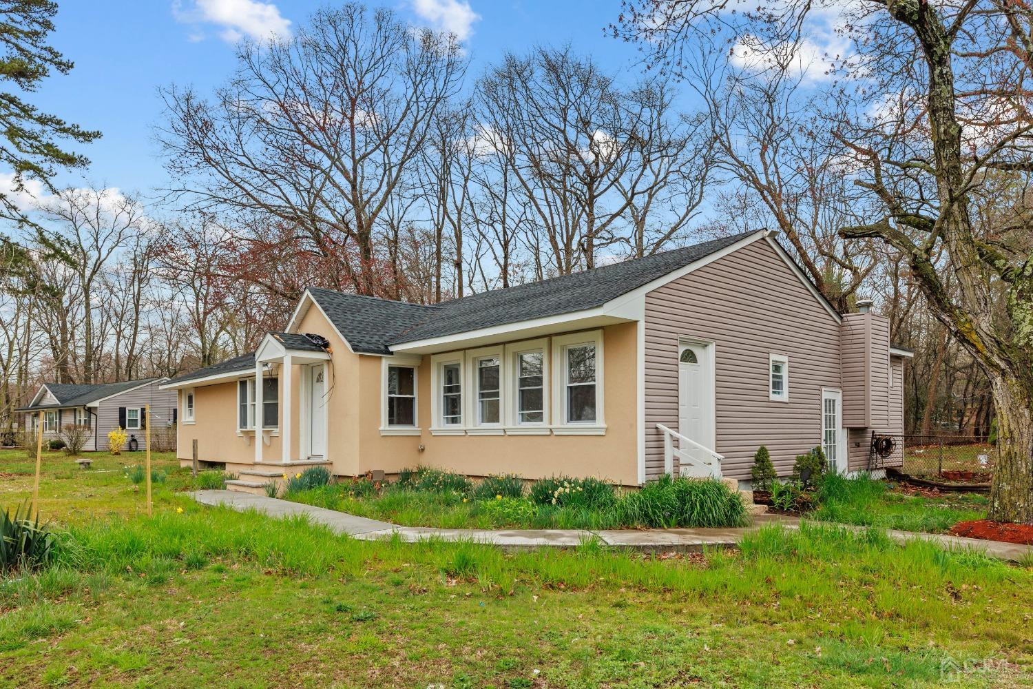 145 Texas Road Old Bridge, NJ 08857 - Photo 8 of 35 a front view of a house with a yard and trees